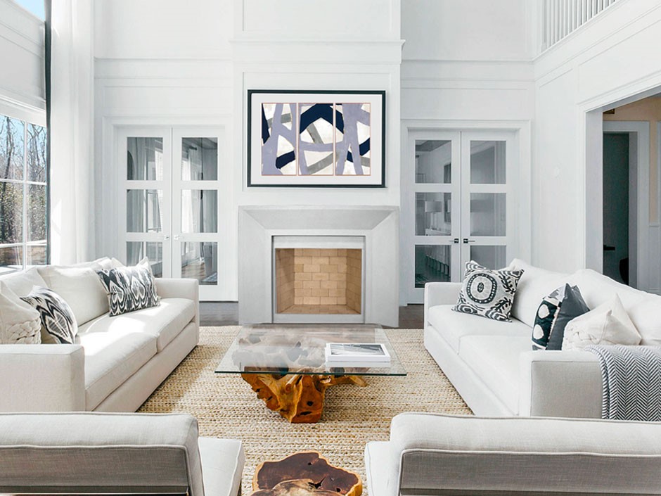 A Newport living room with white couches and a fireplace.
