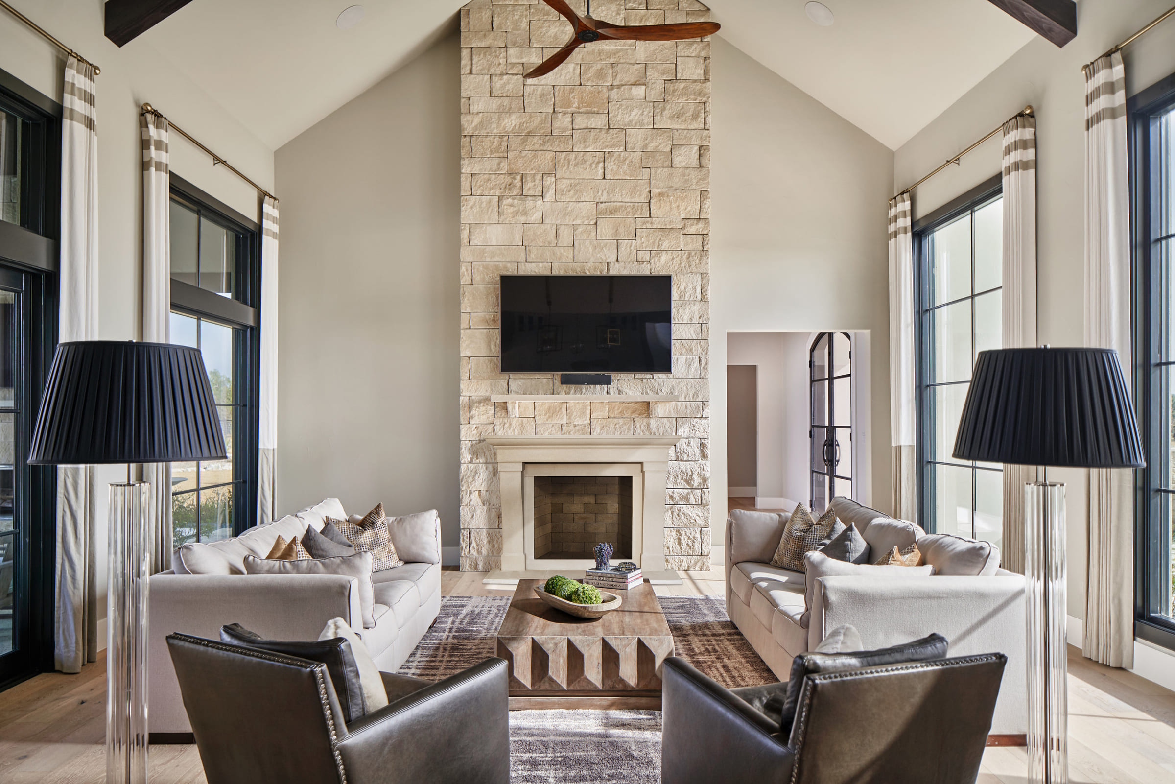 About a living room with a stone fireplace.