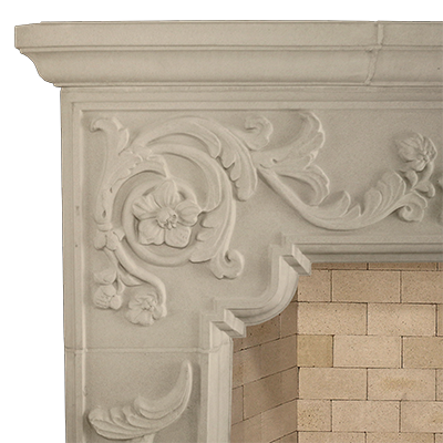A French-inspired white fireplace mantle with a floral design.