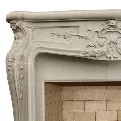 A French ornate fireplace mantle with elaborate carvings.
